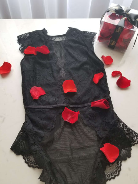 Black lingerie with romantic red rose petals