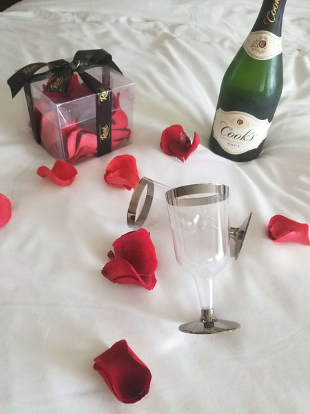 Red Eternal Rose Petals and champagne on bed